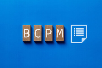 There is wood block with the word BCPM. It is an abbreviation for Business Continuity Plan...