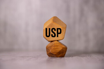 USP text on wooden blocks, financial business concept, blue background. USP