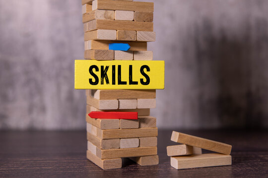 SKILL; Wooden blocks with SKILLs text of concept and a human toy - Powered by Adobe