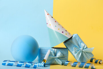 Fototapeta premium Composition with beautiful gift boxes, party hat and balloon on color background