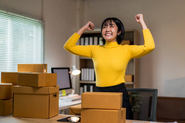 woman in a yellow shirt is standing in front of a pile of cardboard boxes