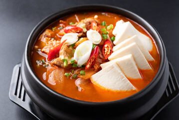 Korean food (Kimchi Jjigae), Kimchi soup with tofu, pork, scallion and chili in Korean stone bowl...