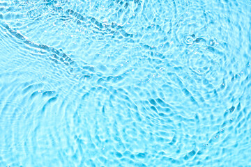 Texture of water with splashes on blue background, top view