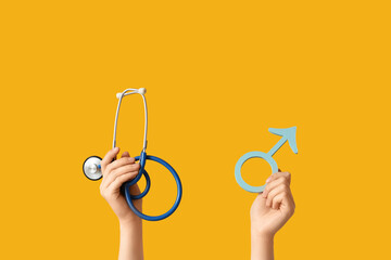Female hands with symbol of man and stethoscope on yellow background. Prostate Cancer Awareness...