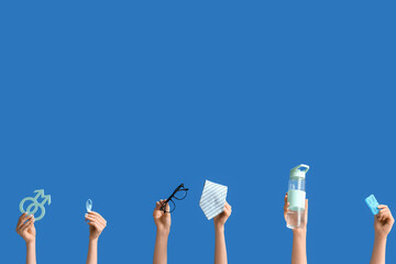 Female hands with symbols of man, blue ribbon and accessories on color background. Prostate Cancer...