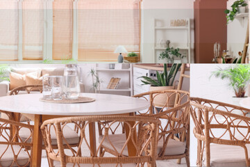 Table with jug and glasses of water in kitchen, closeup
