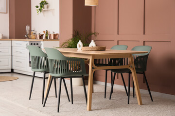Wooden dining table and chairs in stylish kitchen
