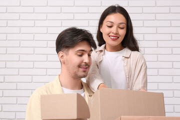 Young couple with parcel boxes at home