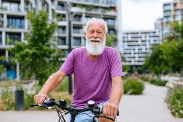 Active and happy senior man with a bicycle in a city park embracing a healthy lifestyle