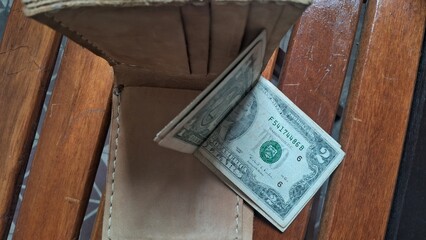 Elegant leather wallet with dollar bills inside