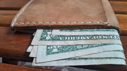 Elegant leather wallet with dollar bills inside