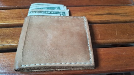 Elegant leather wallet with dollar bills inside