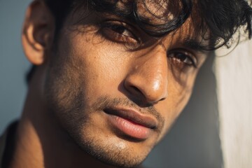 Obraz premium Image of attractive young Indian man outdoors with natural light and a simple backdrop