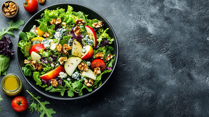 Fresh colorful vegetable salad in black bowl with mixed greens cherry tomatoes cucumber radishes...