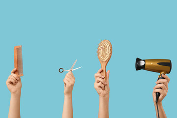 Female hands with different hairdresser's supplies on blue background
