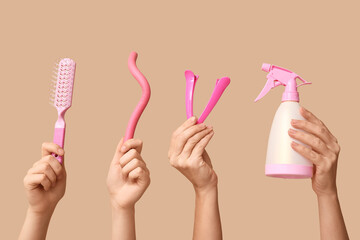 Female hands with different hairdresser's supplies on beige background