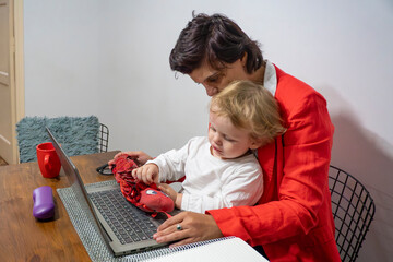 Female entrepreneur trying to work while babysitting her child