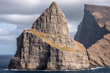 Coastal craggy pinnacle, dramatic rock formation