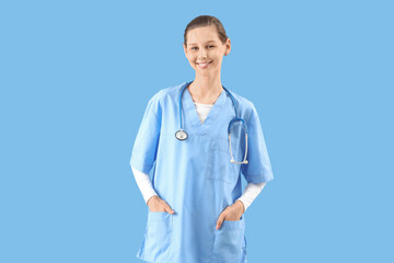 Female medical intern on blue background