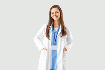 Female medical intern on light background