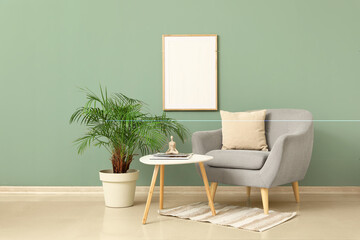 Interior of stylish living room with grey armchair, houseplant and coffee table