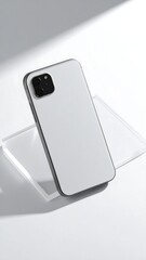 Sleek white smartphone with dark frame on a minimalist studio background