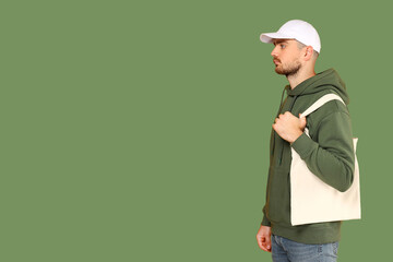 Young adult carries a stylish tote bag while wearing a hoodie