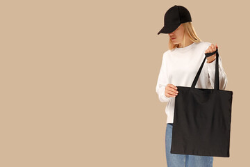 Female model displays a stylish black tote bag in casual attire