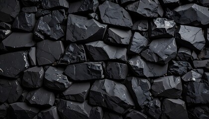 Wall of natural black coal. Abstract background of dark carbon stones, a source of fossil fuel and energy.