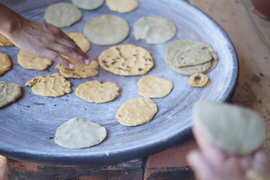 Traditional tortilla making in Guatemala with comal plate 