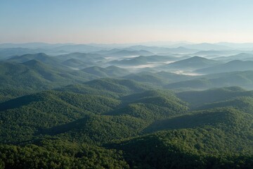 Fototapeta premium Misty mountain range at dawn. Lush green hills fade into hazy blue distance