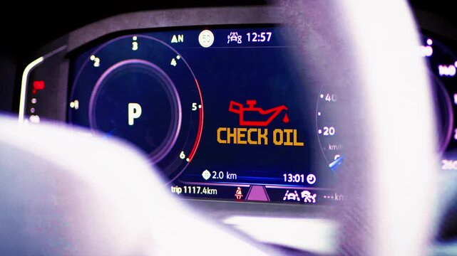 Digital cockpit of a modern car and a Check Oil warning light