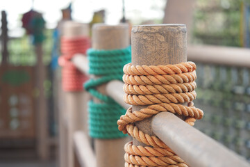 Ropes tied around wooden posts in outdoor space