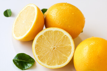 Fresh and vibrant lemons, with one perfectly sliced to reveal its juicy interior, scattered with...
