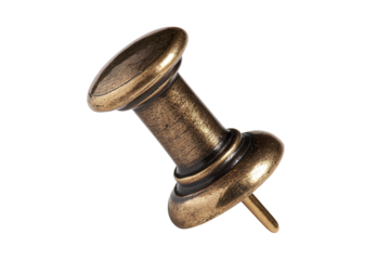 Close-up of a decorative antique-style push pin.  The pin's brass-colored metal is highlighted against a black background.  Rounded head and shank are visible