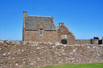 Ruins of Dunnottar Castle on Scotland's North Sea coast under a clear sky