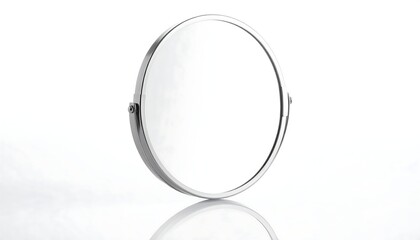 Fototapeta premium Circular mirror with a silver frame and adjustable stand, reflecting on a white surface
