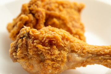 crispy fried chicken on white plate close up