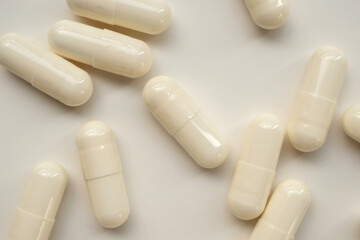 White medicine pills capsule on white background