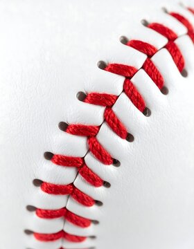 Close-up of a white baseball's red stitching