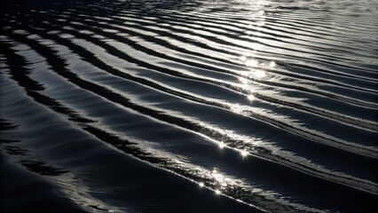 Sunlight shimmers on rippling dark water surface