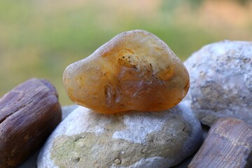 raw amber stone on rocks