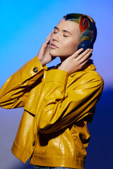 Obraz premium woman with colorful artistic hair wearing yellow jacket enjoys music, closed eyes, serene expression, vibrant background, creative fashion portrait