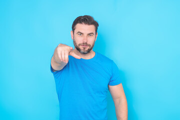 The point you. Happy handsome man pointing finger you away, isolated blue background. Excited man...