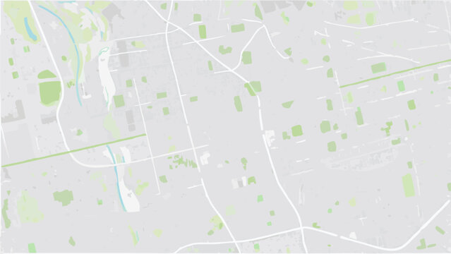 Vector aerial view of a city with light gray buildings green patches and white roads creating an abstract pattern