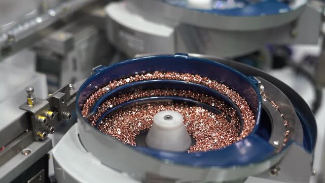 Factory Industrial machinery is working to produce steel nut in an industrial factory. Metallic nut process production