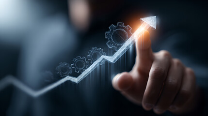 Obraz premium Businessman's hand touching a holographic line graph with cogs and an upward arrow, representing business growth and progress.