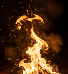 Dynamic orange flames dance with glowing embers and wisps of smoke against a dark background, creating a captivating visual of intense heat and energy.