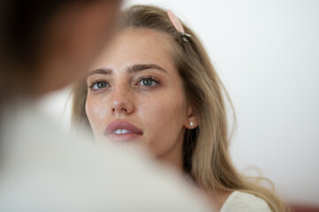 Beauty makeup. Makeup model applies powder and eye shadow blush. Visagiste, cosmetics make up of...