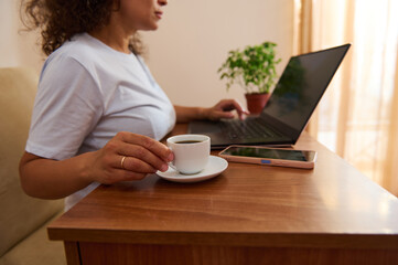 Woman Working Remotely At a Cozy Home Desk With Laptop and Coffee